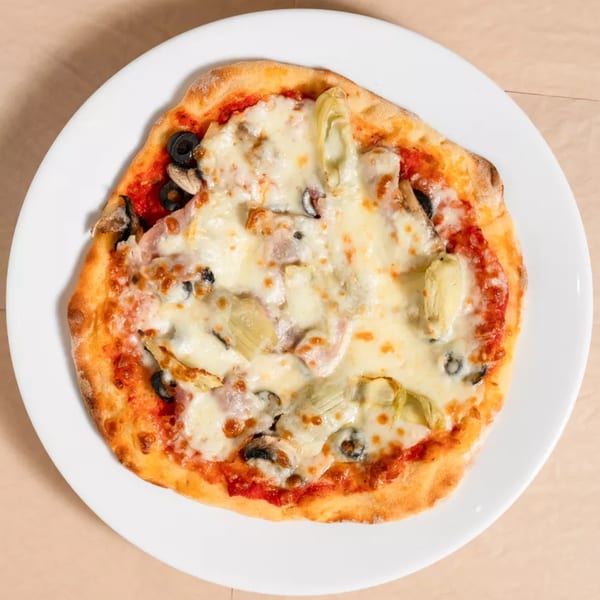 A small, round pizza with melted cheese, tomato sauce, olives, mushrooms, and artichoke hearts.